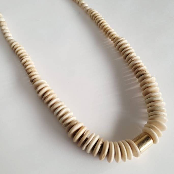 Handmade bold beaded bone necklace with brass bead